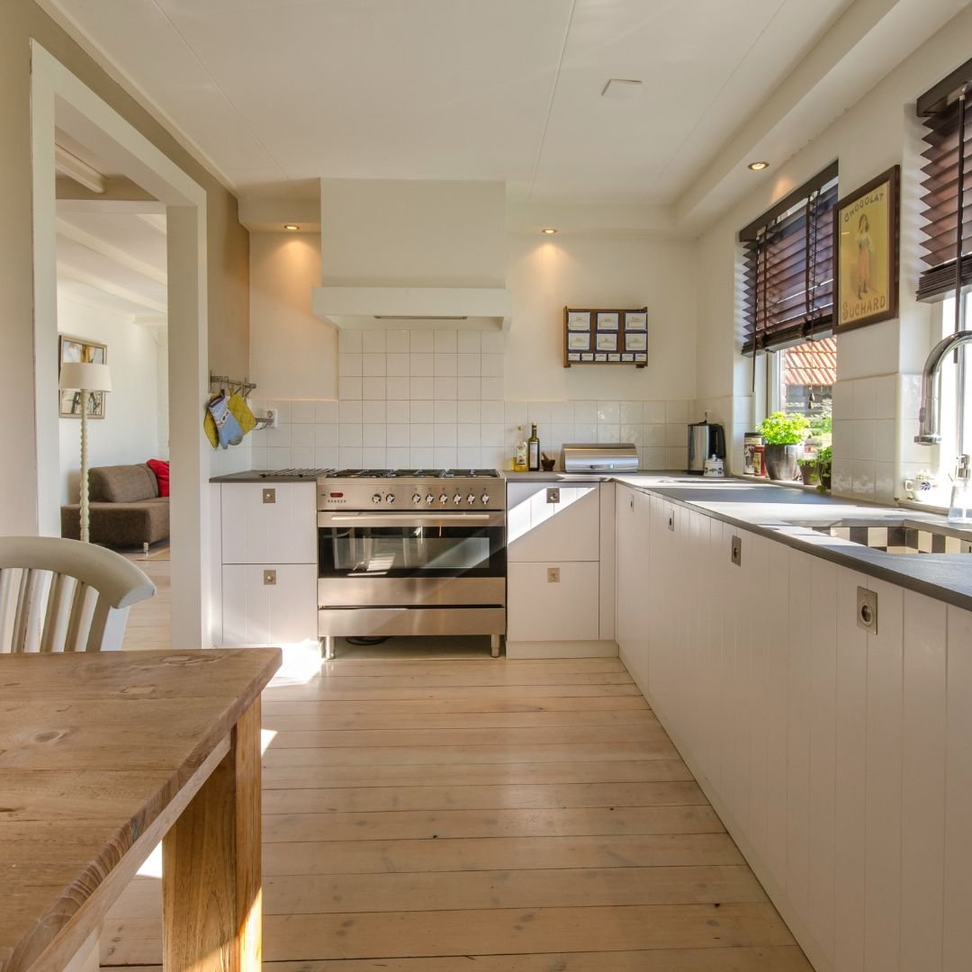 A kitchen with a wood floor and a table.